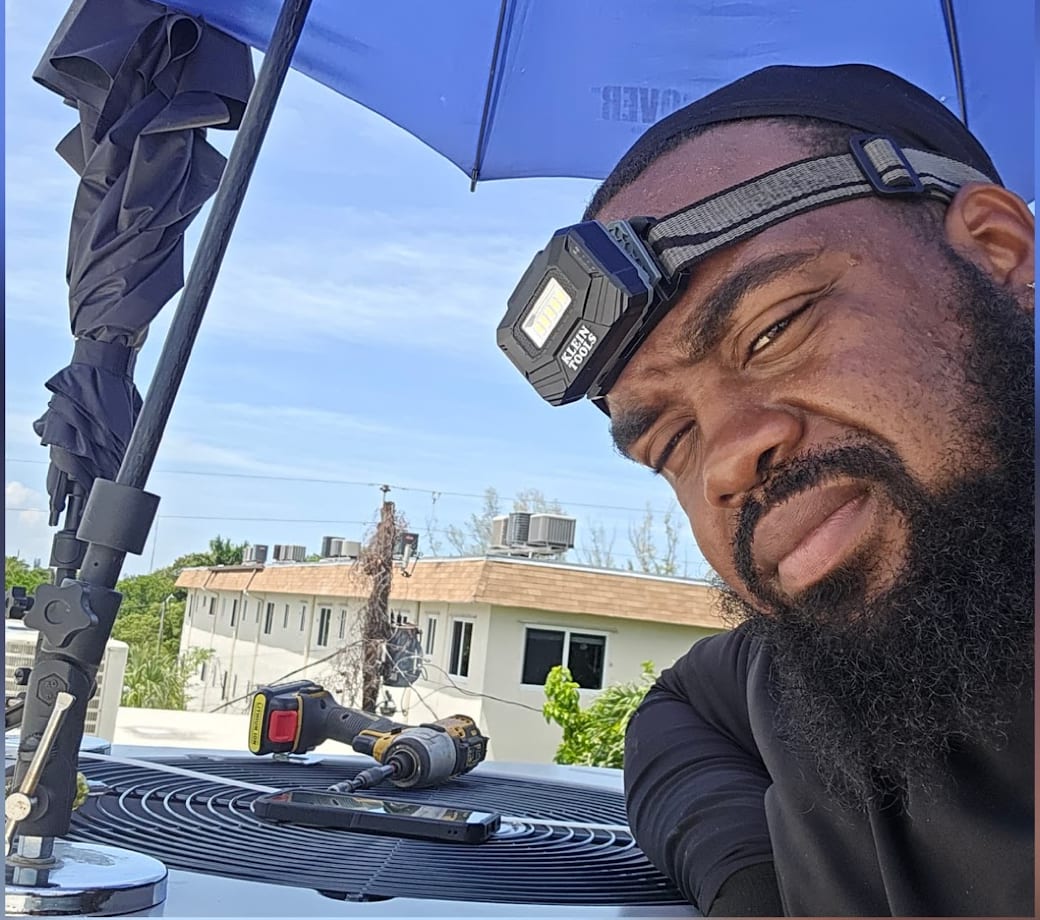 Irie Breeze owner Alex on a rooftop AC job in South Florida